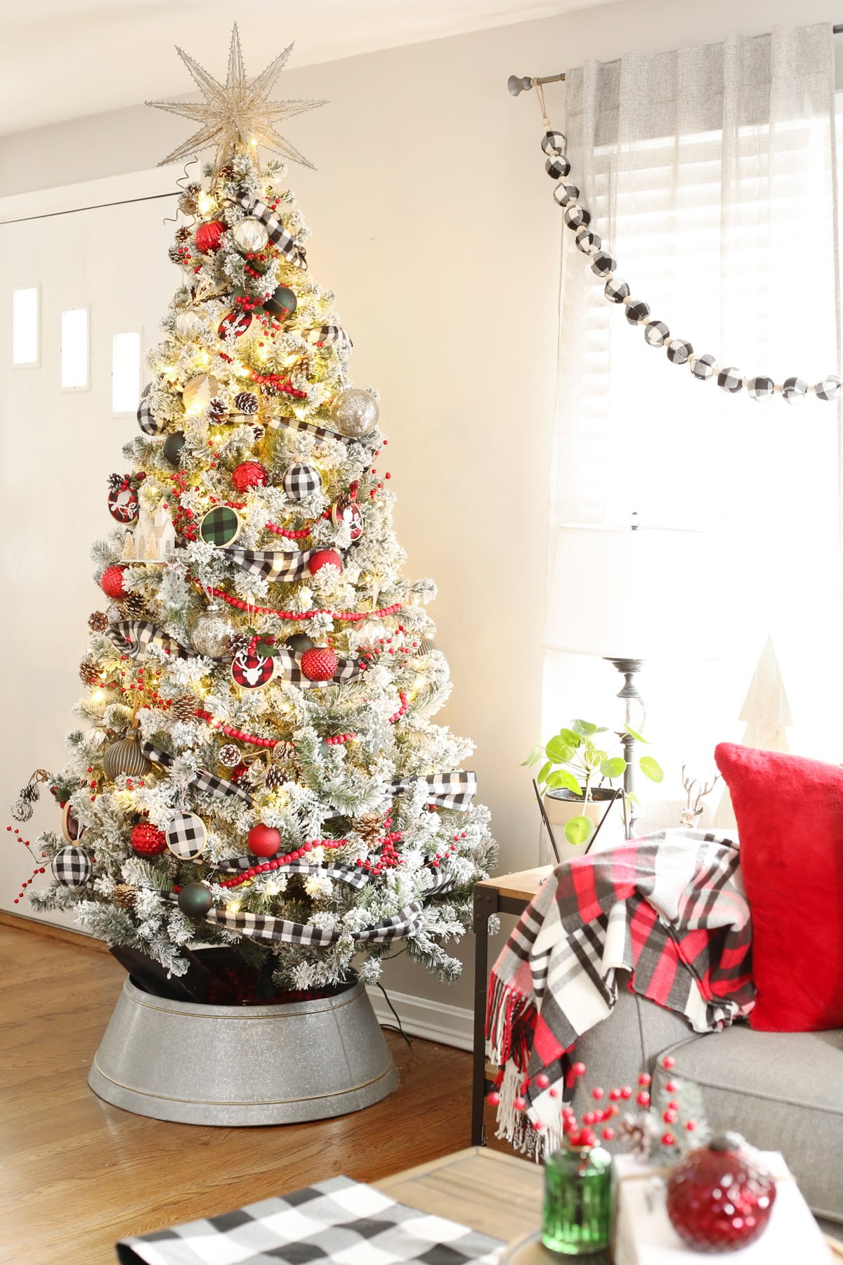 A Buffalo Check Flocked Christmas Tree in a living room. 