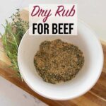 Dry Rub For Beef in a white ramekin sitting on a wooden board on top of the kitchen counter.