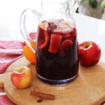 A kitchen counter with a pitcher of red sangria.