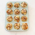 Light blue muffin tin filled with french toast on a kitchen counter.