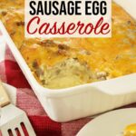 Sausage egg casserole in white casserole dish with spatula off to the side on top of kitchen counter.