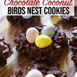 Chocolate coconut birds nest cookies are arranged on top of a wooden board.