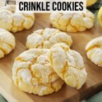 Lemon crinkle cookies sit on a wooden board and cooling rack on top of the kitchen counter.