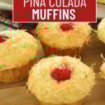 Pina colada muffins on a wooden cutting board.