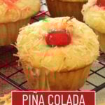 Pina colada muffins on a wooden cutting board.